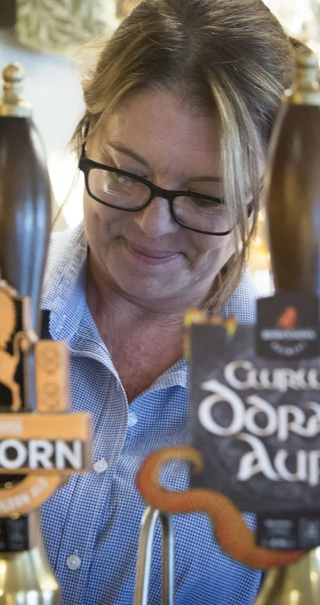 A lady pouring a pint