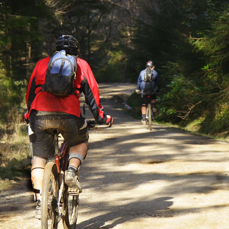 A person in a red shirt cycling