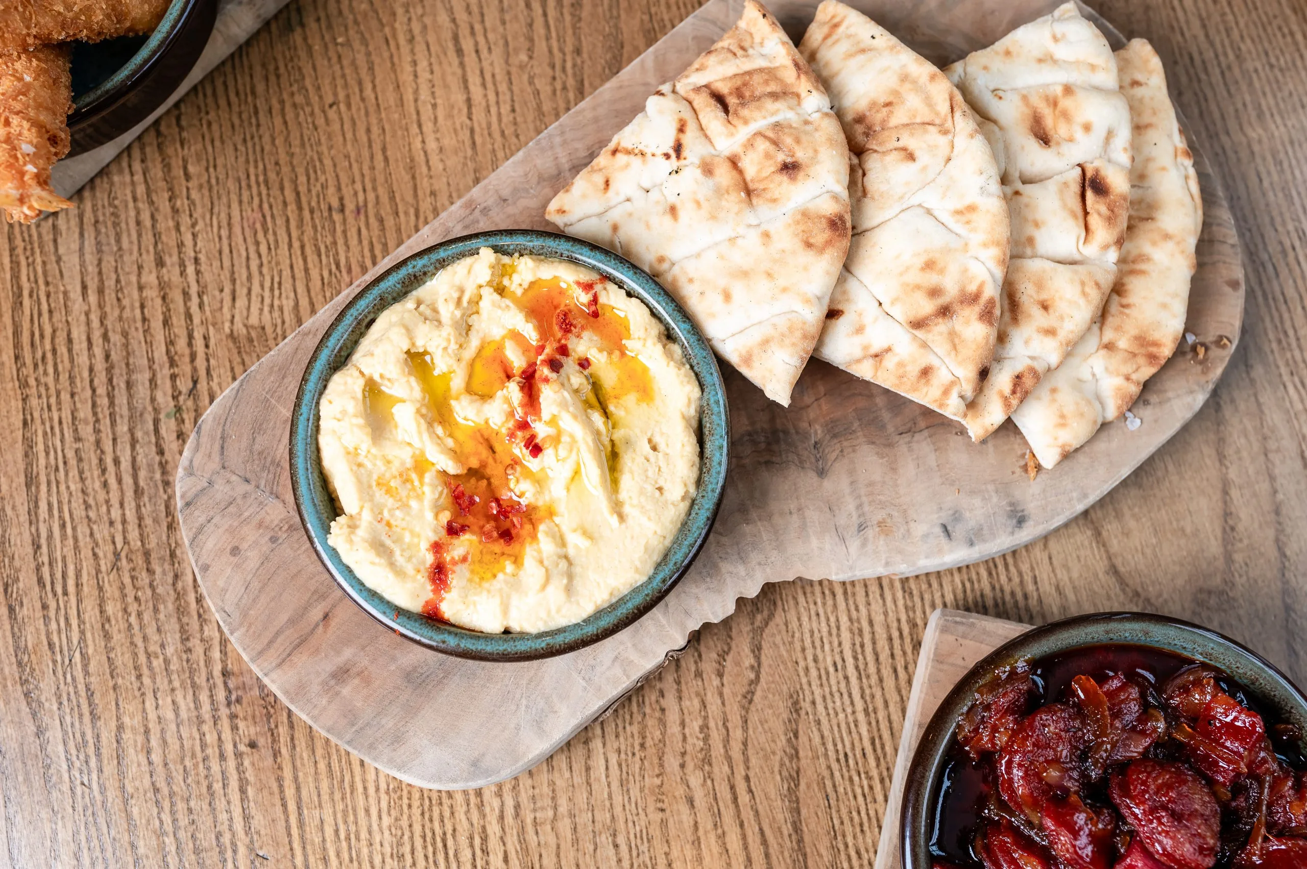 Pitta bread next to a dish.