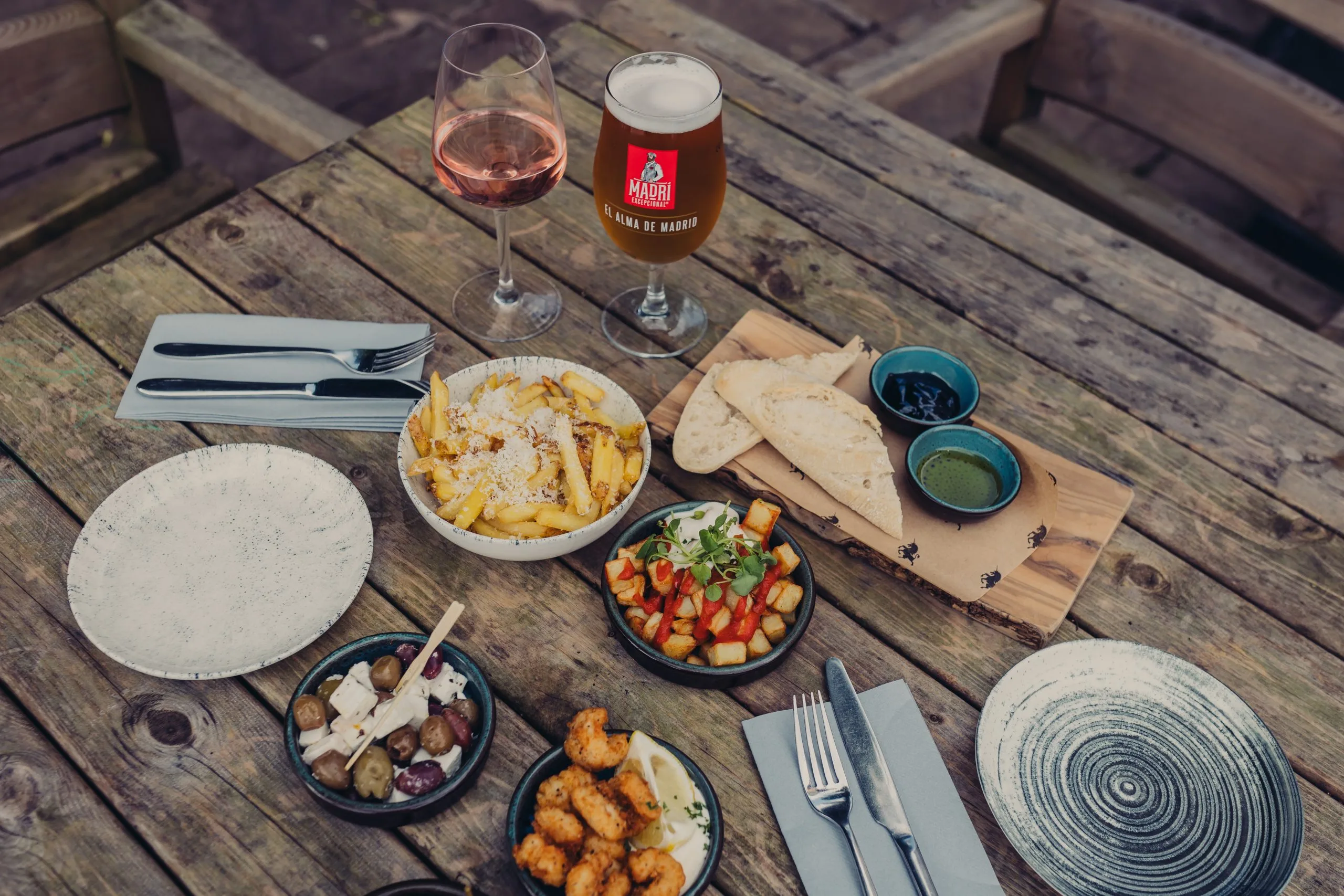 Various small dishes on a table with someone putting their fork into one