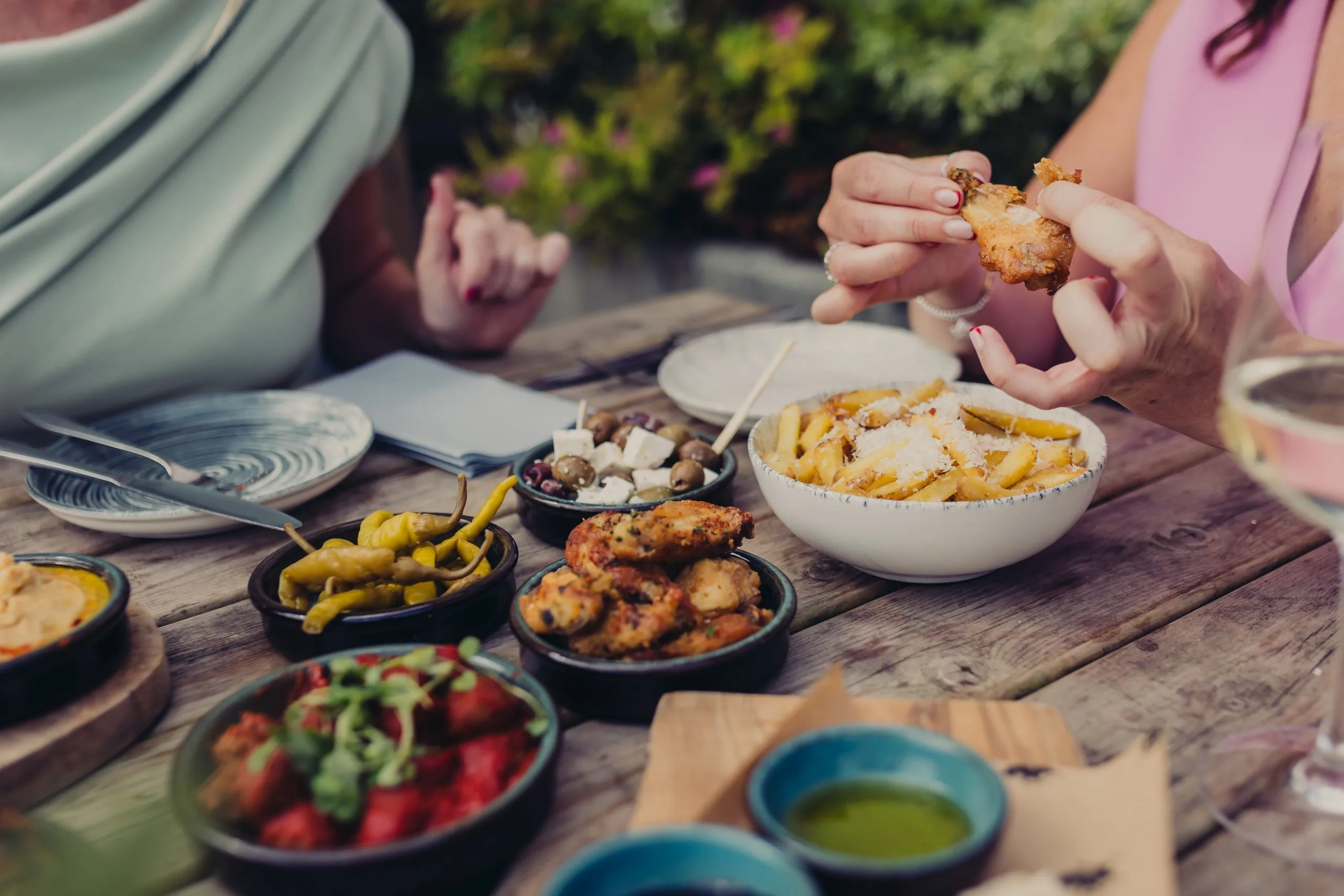 Various small dishes on a table with someone putting their fork into one