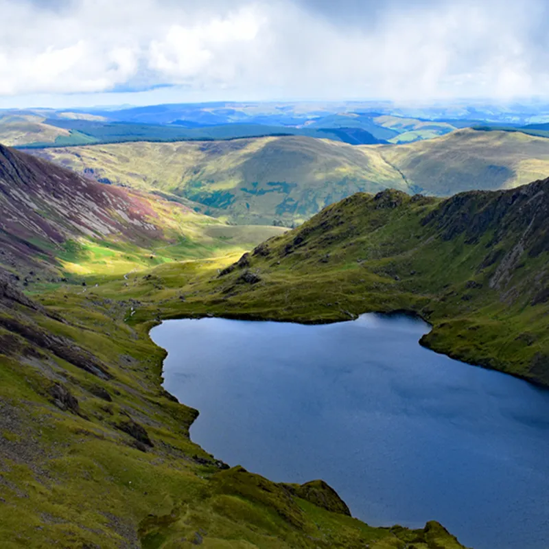 A landscape shot of mountains and water in the middle of them