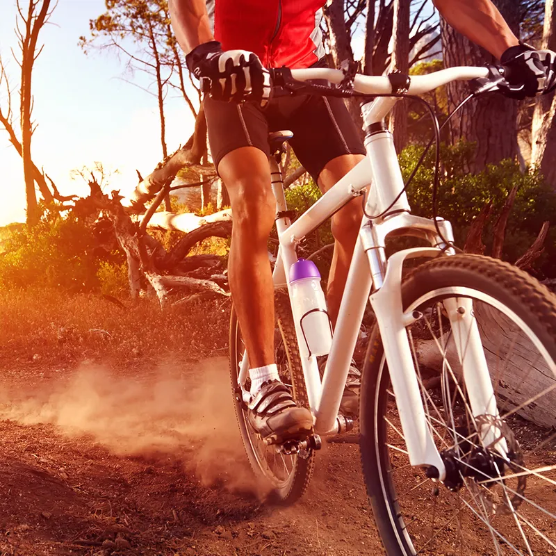 Someone cycling with dust in view